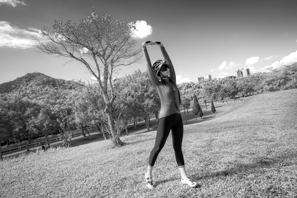 woman in black tank top and black shorts standing on grass field