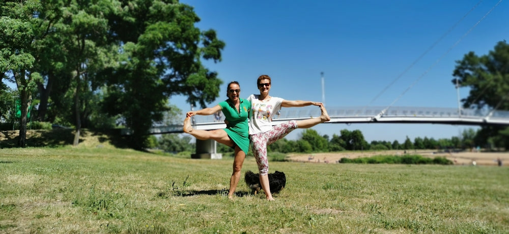 man in teal crew neck t-shirt and brown shorts jumping on green grass field during